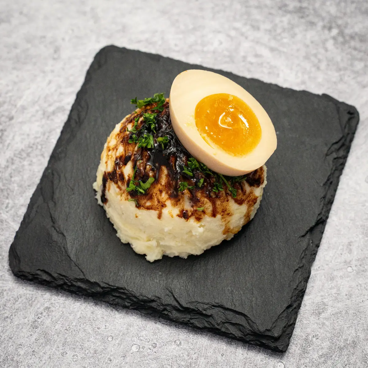 Gachi Potato Salad - Creamy potatoes with Kewpie mayo, a soft-boiled egg, black garlic oil, and rice crispies